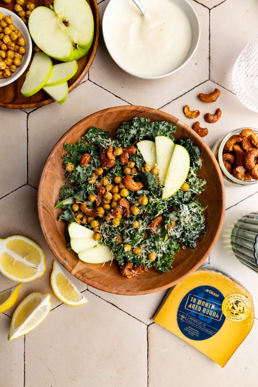 a bowl of cashew kale Caesar salad topped with crispy chickpeas, candied cashews and apples.