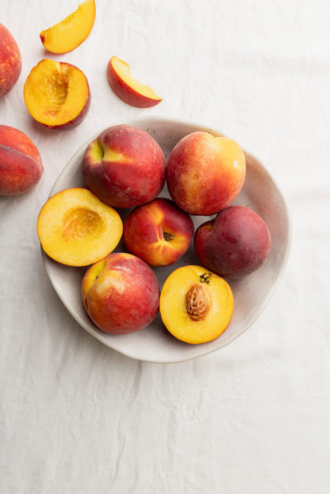 a bowl of yellow peaches