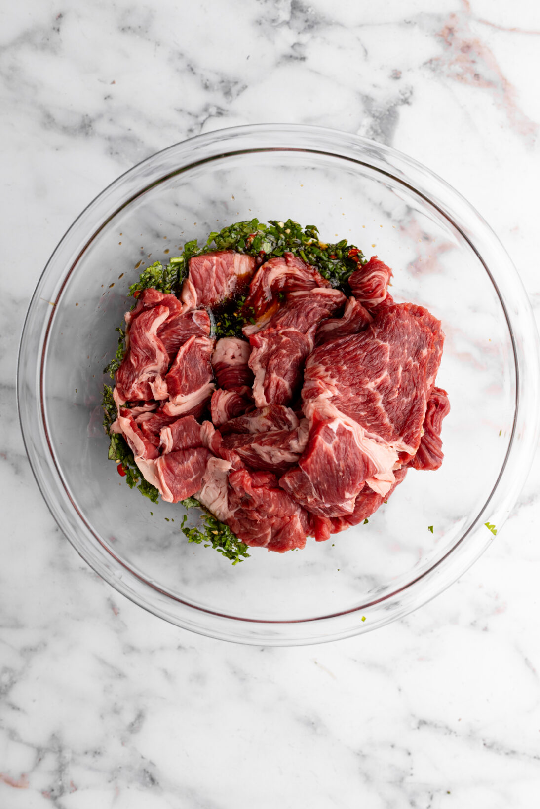 the beef added to the bowl of marinade