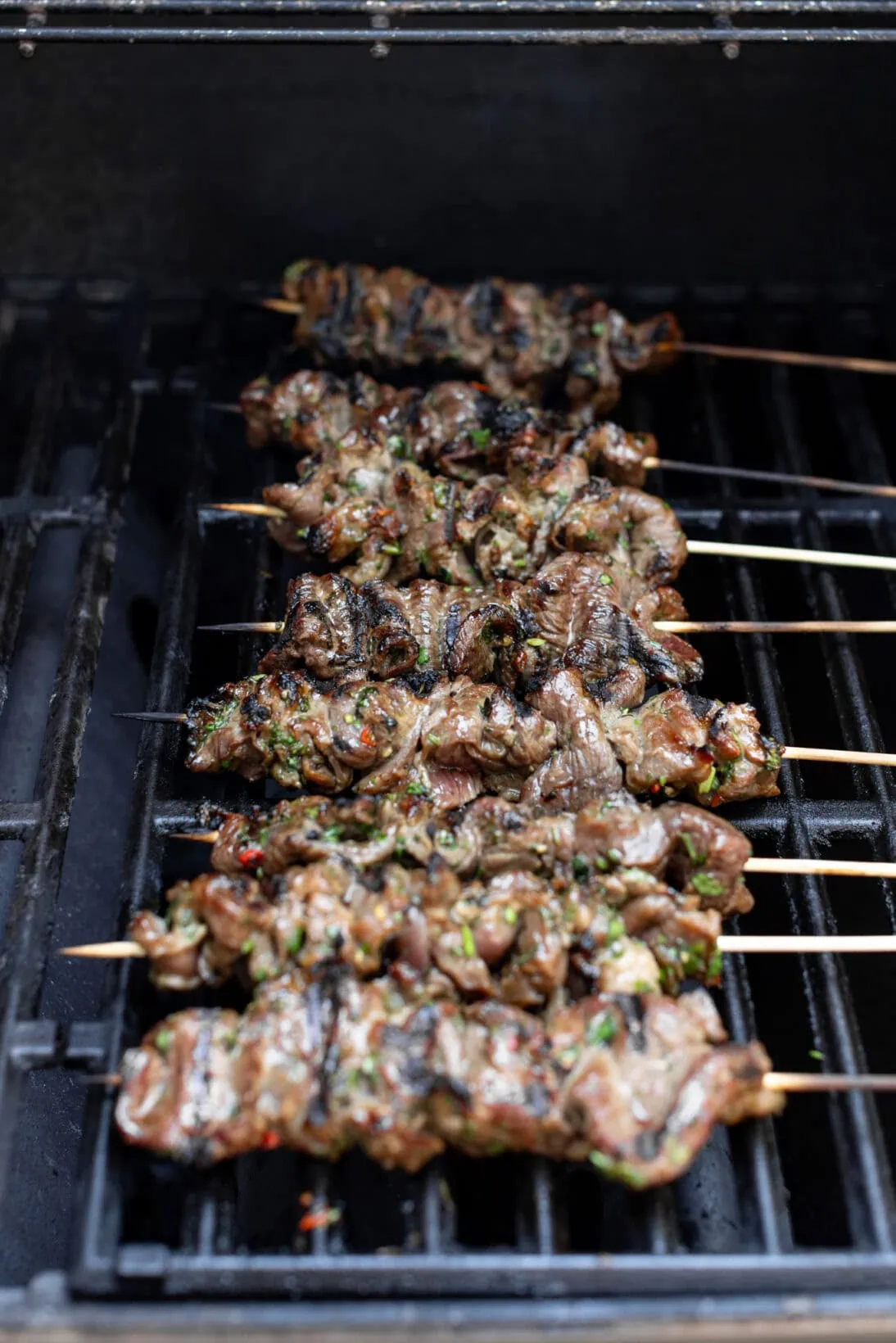 grilling the beef satay skewers