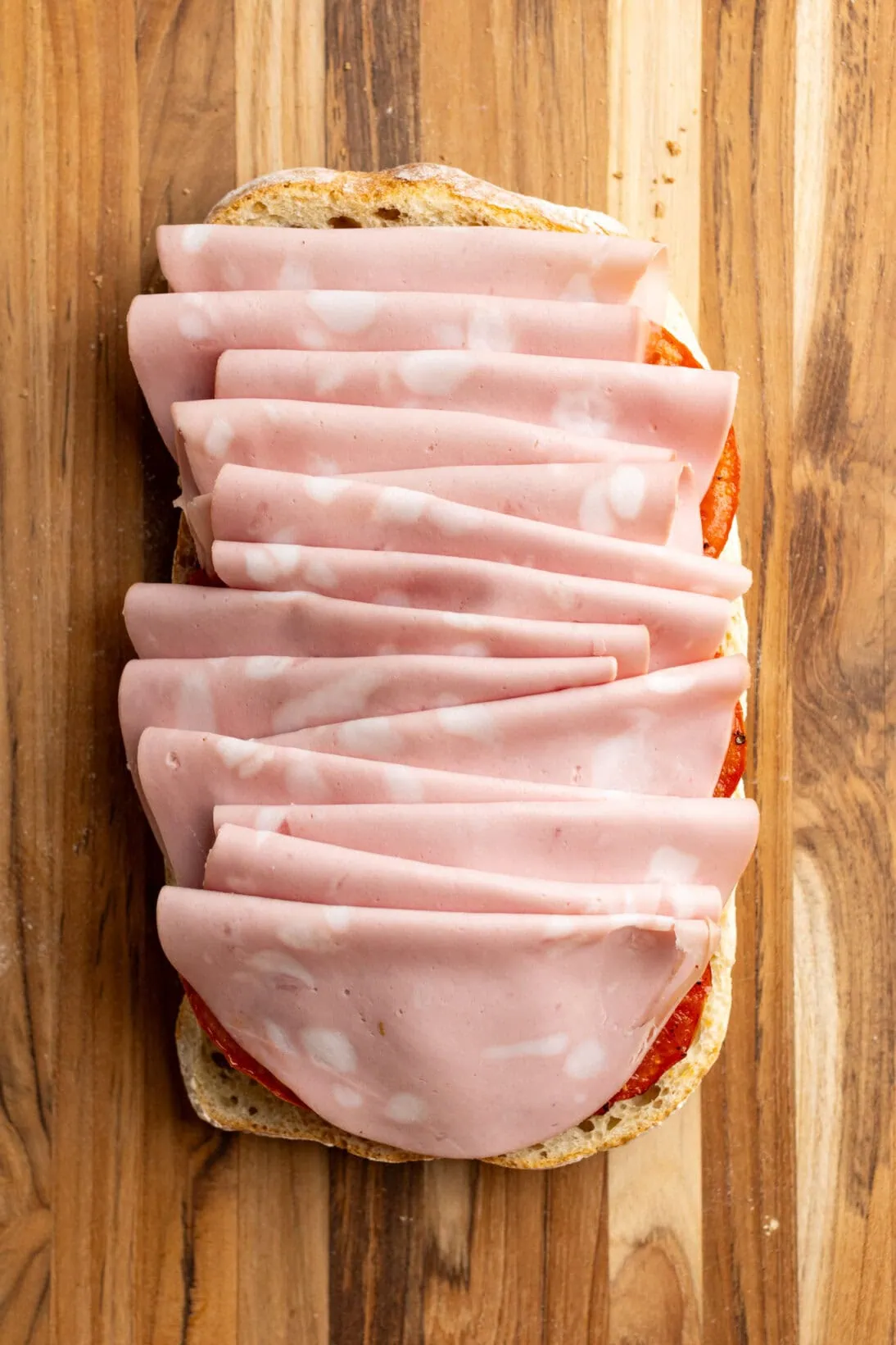 ciabatta loaf with layers of mortadella.