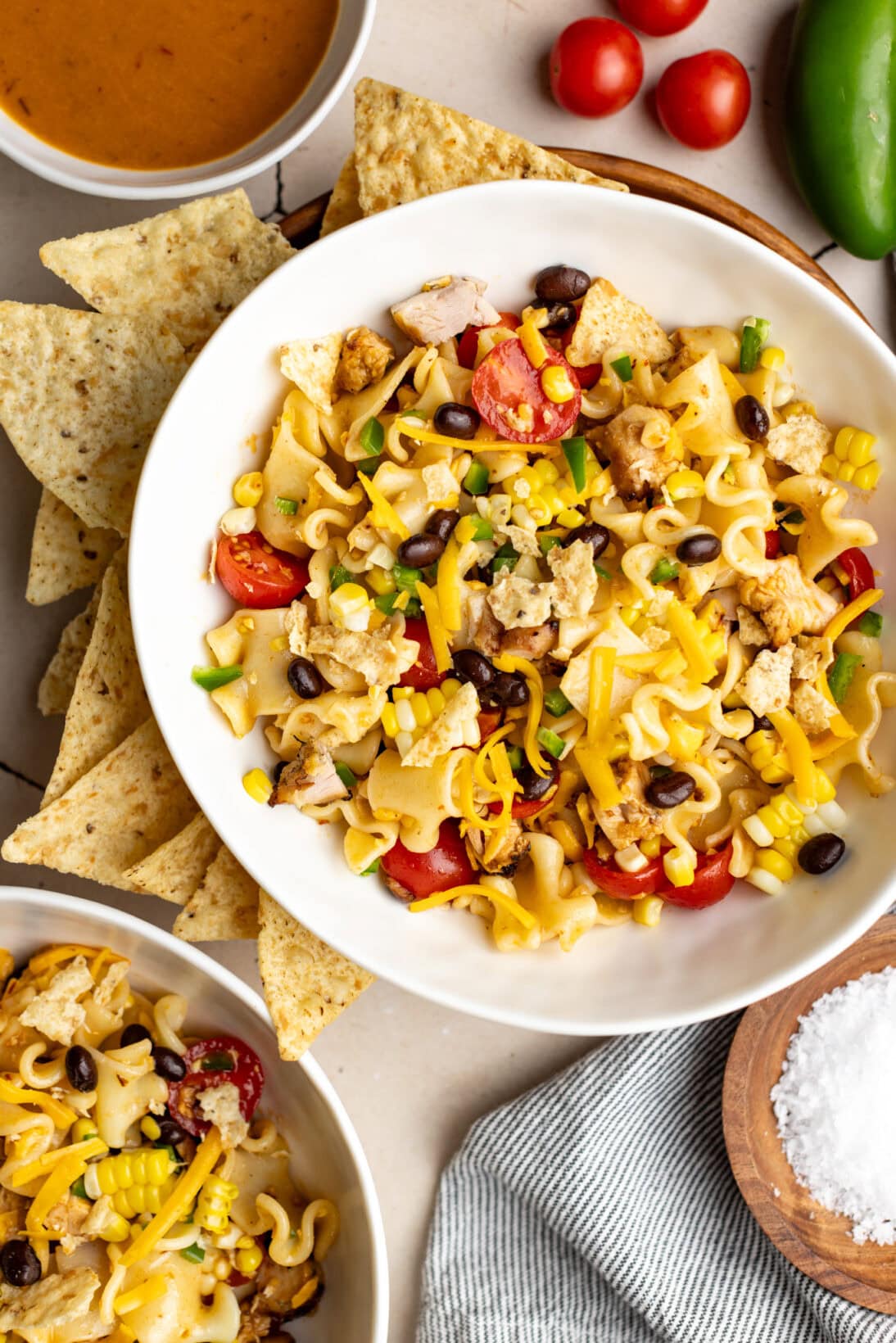 chipotle southwest pasta salad in a bowl surrounded by tortilla chips. 