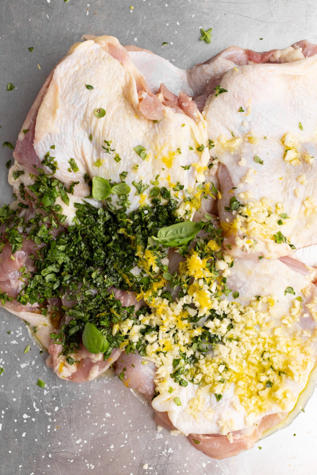 the uncooked chicken with the ingredients layered on top for seasoning.