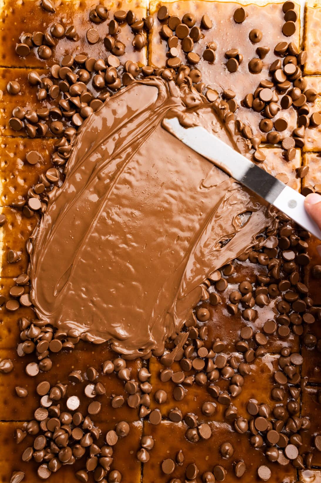 spreading chocolate across the bars