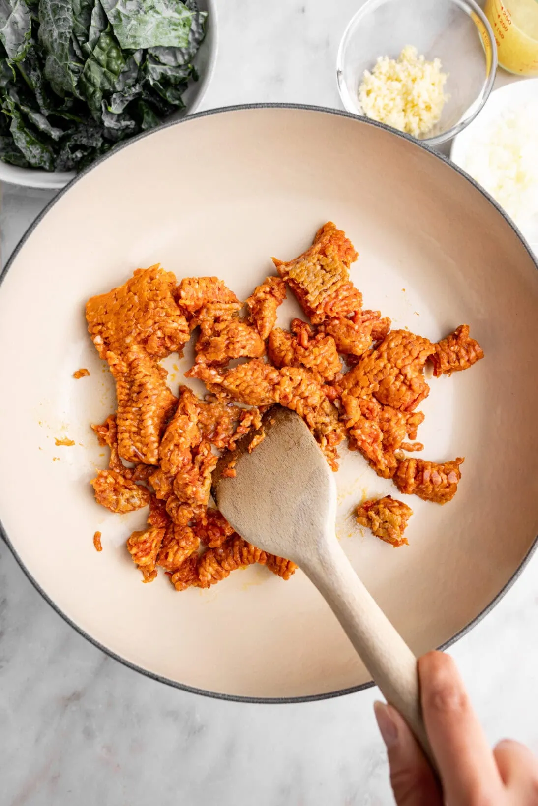 step by step photo: breaking the sausage up with a spoon