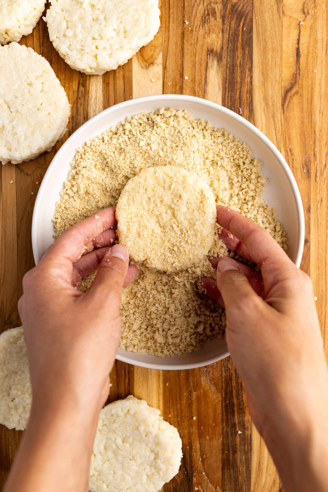 breading the cakes in a mixture of panko and Italian breadcrumbs