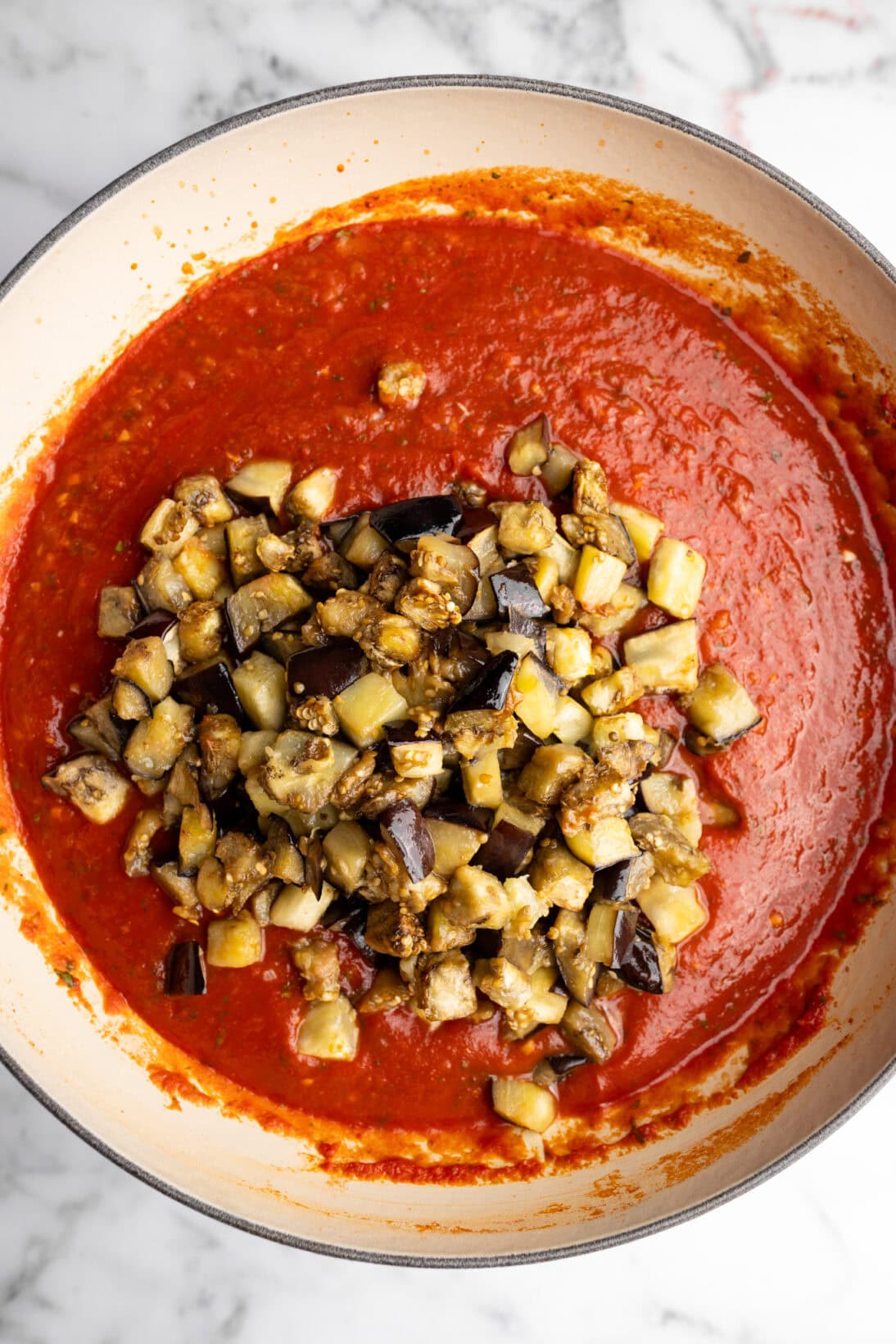 adding the eggplant to the simmered sauce