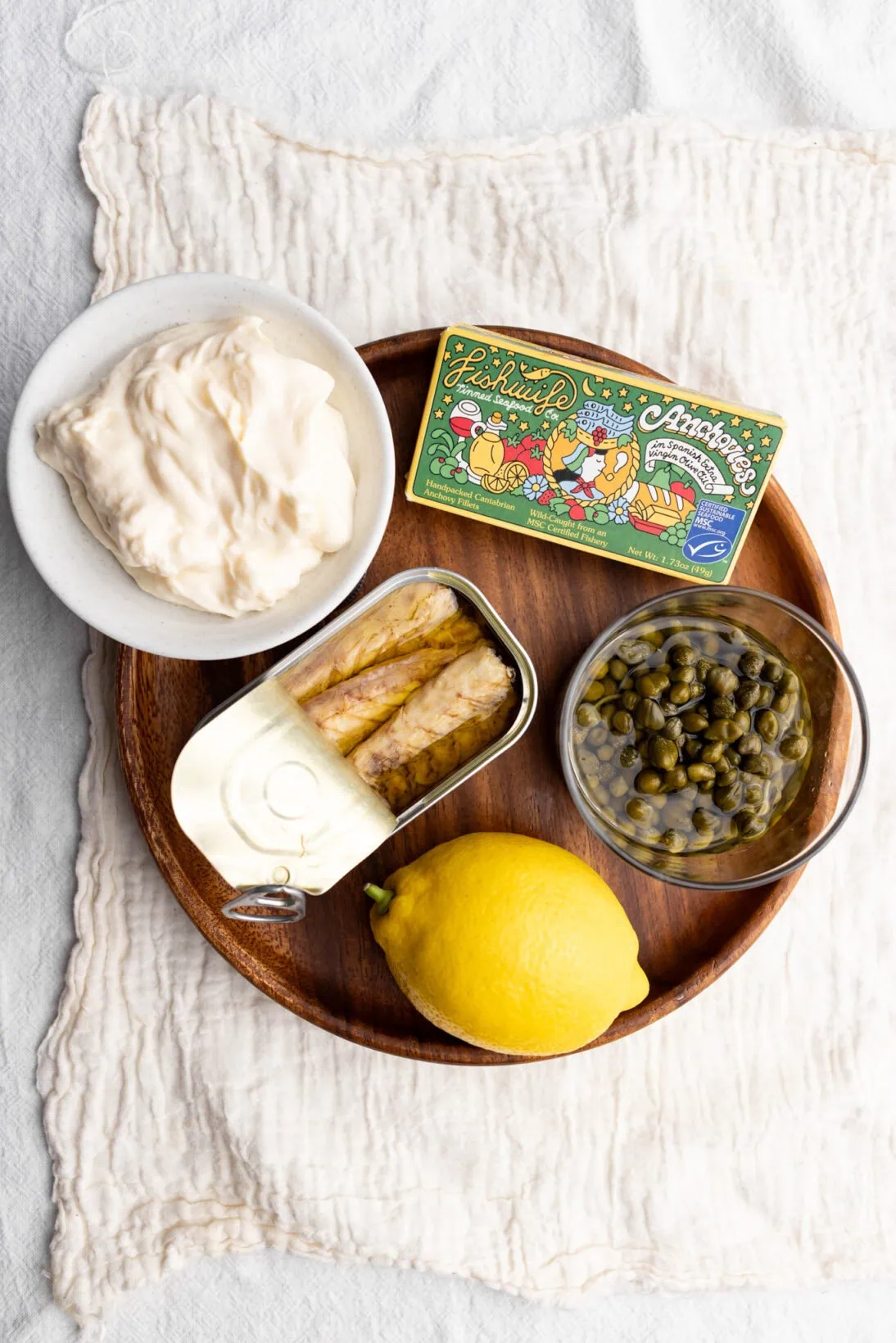 the ingredients laid out. Mayo, tinned mackerel, anchovies, capers and a lemon.