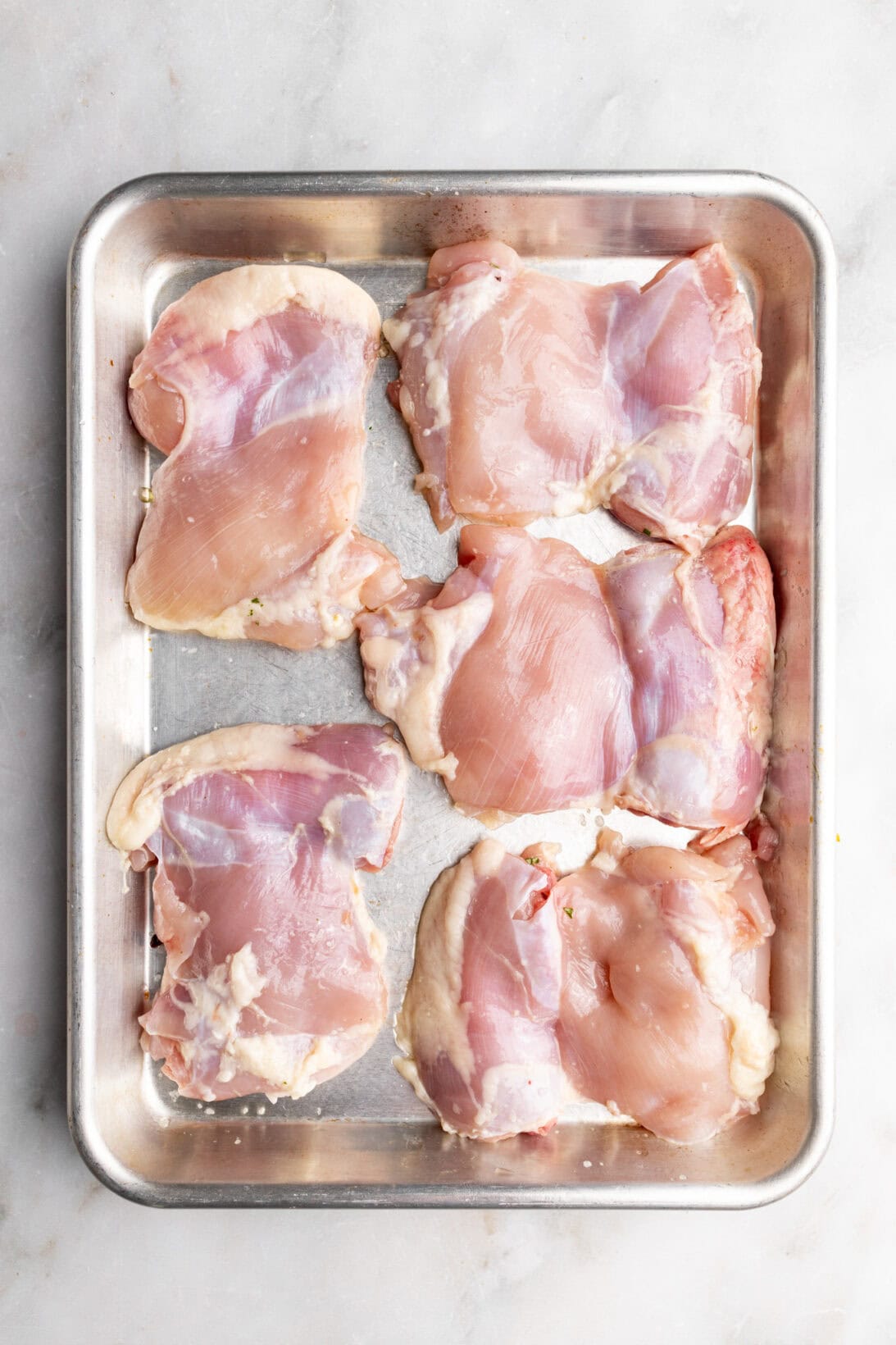step by step: raw chicken on a sheetpan