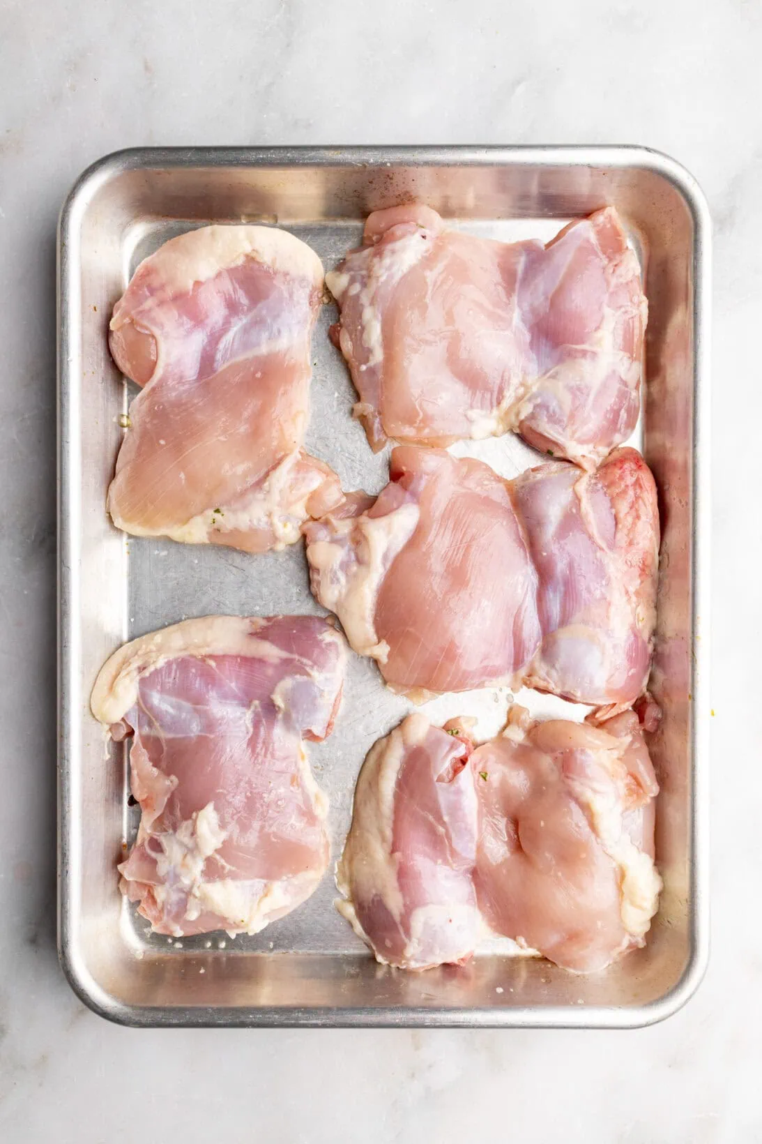 step by step: raw chicken on a sheetpan