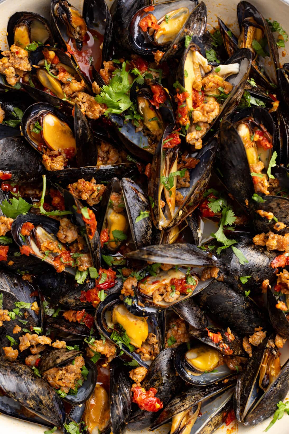 up close shot of spicy mussels in white wine sauce