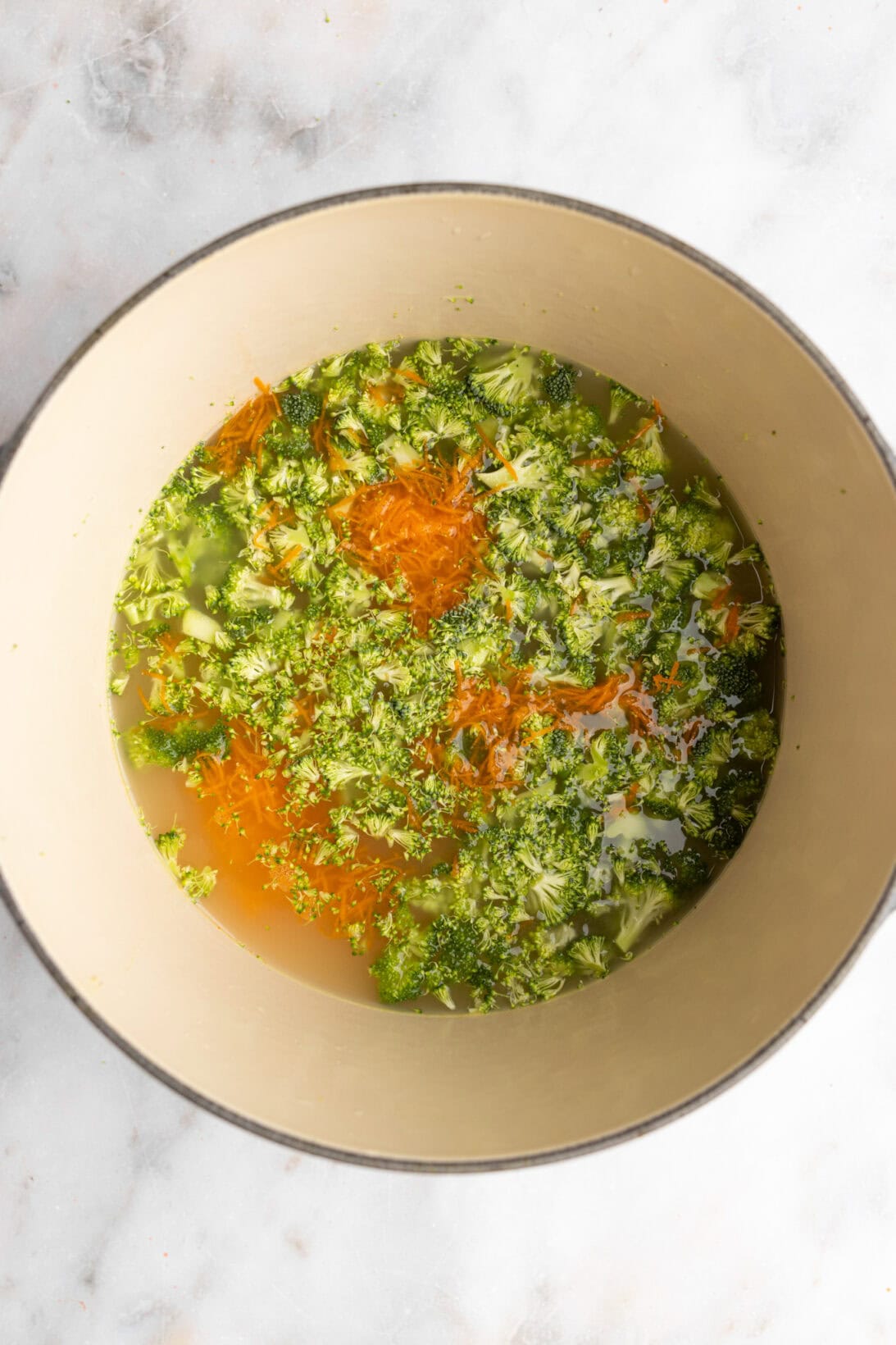 step by step: simmering the broccoli with carrots in broth