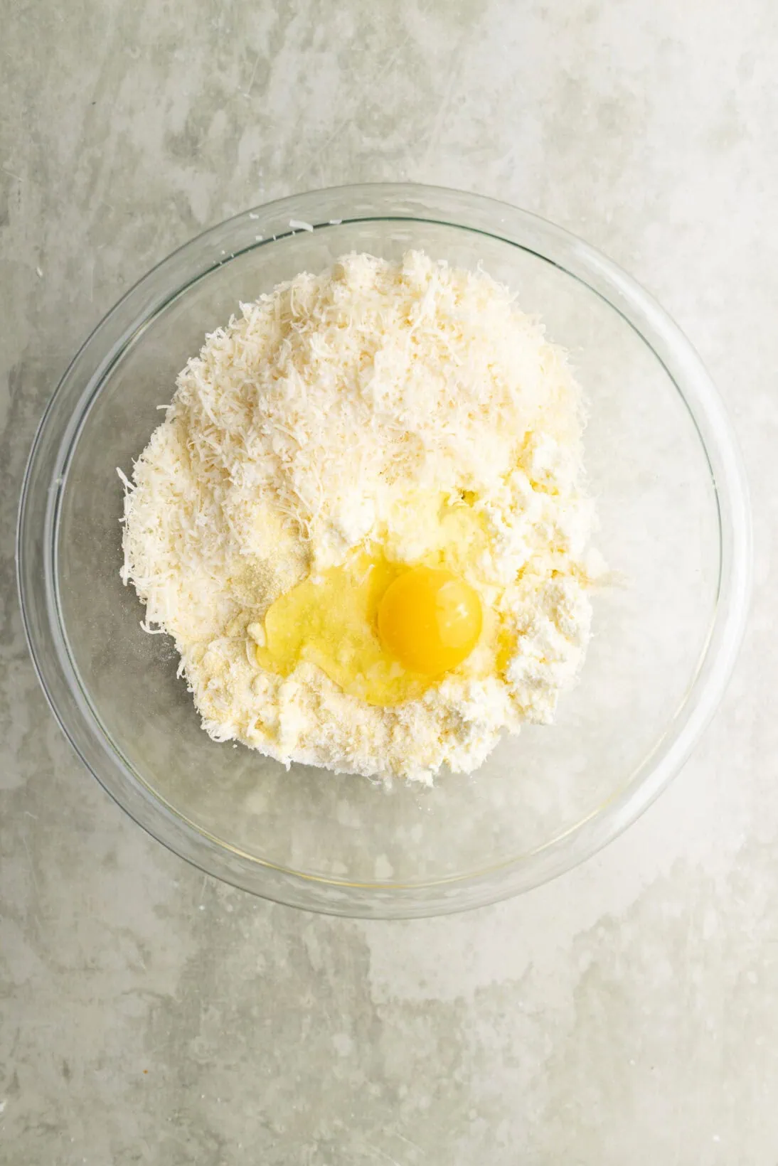bowl of ingredients: ricotta, parm, egg and semolina flour.  