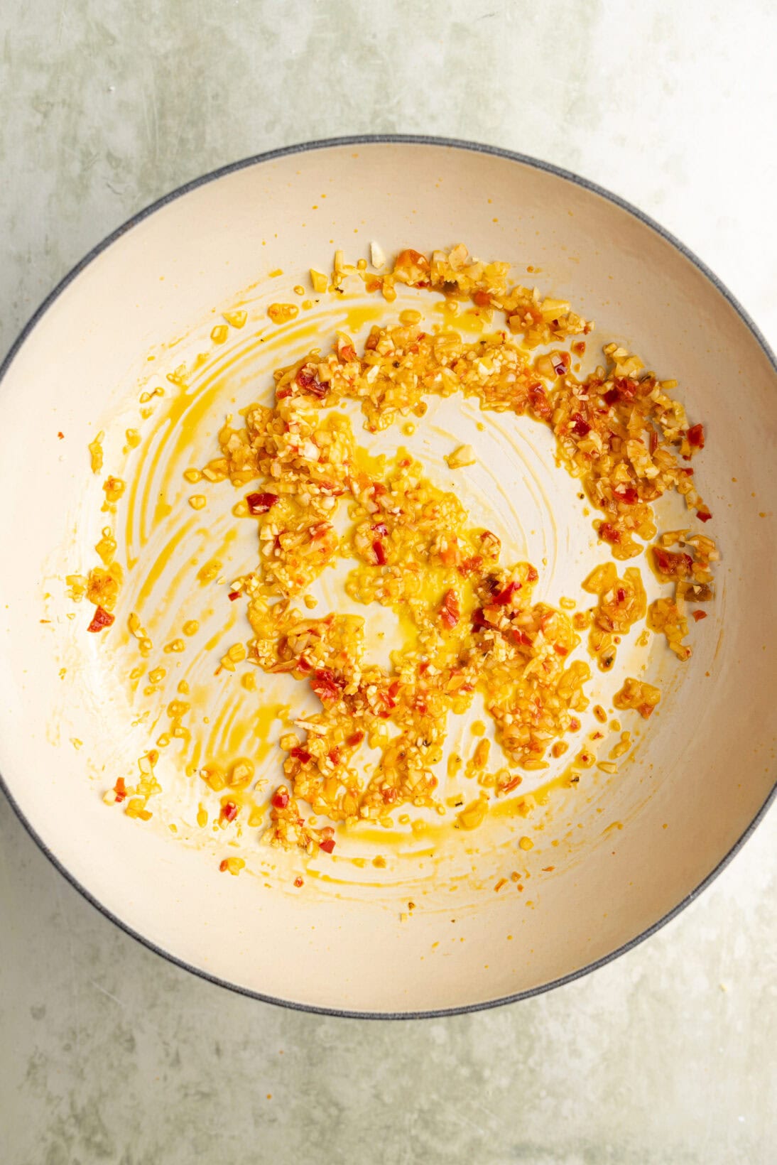 step by step spicy marinara: sautéing the garlic and Calabrian chilies in olive oil.