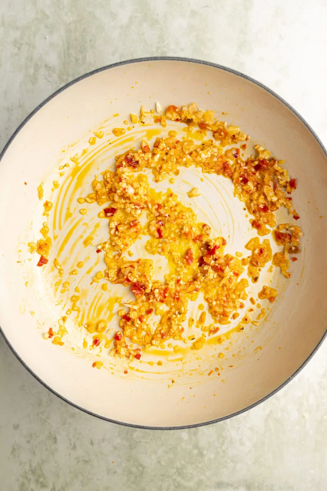step by step spicy marinara: sautéing the garlic and Calabrian chilies in olive oil.