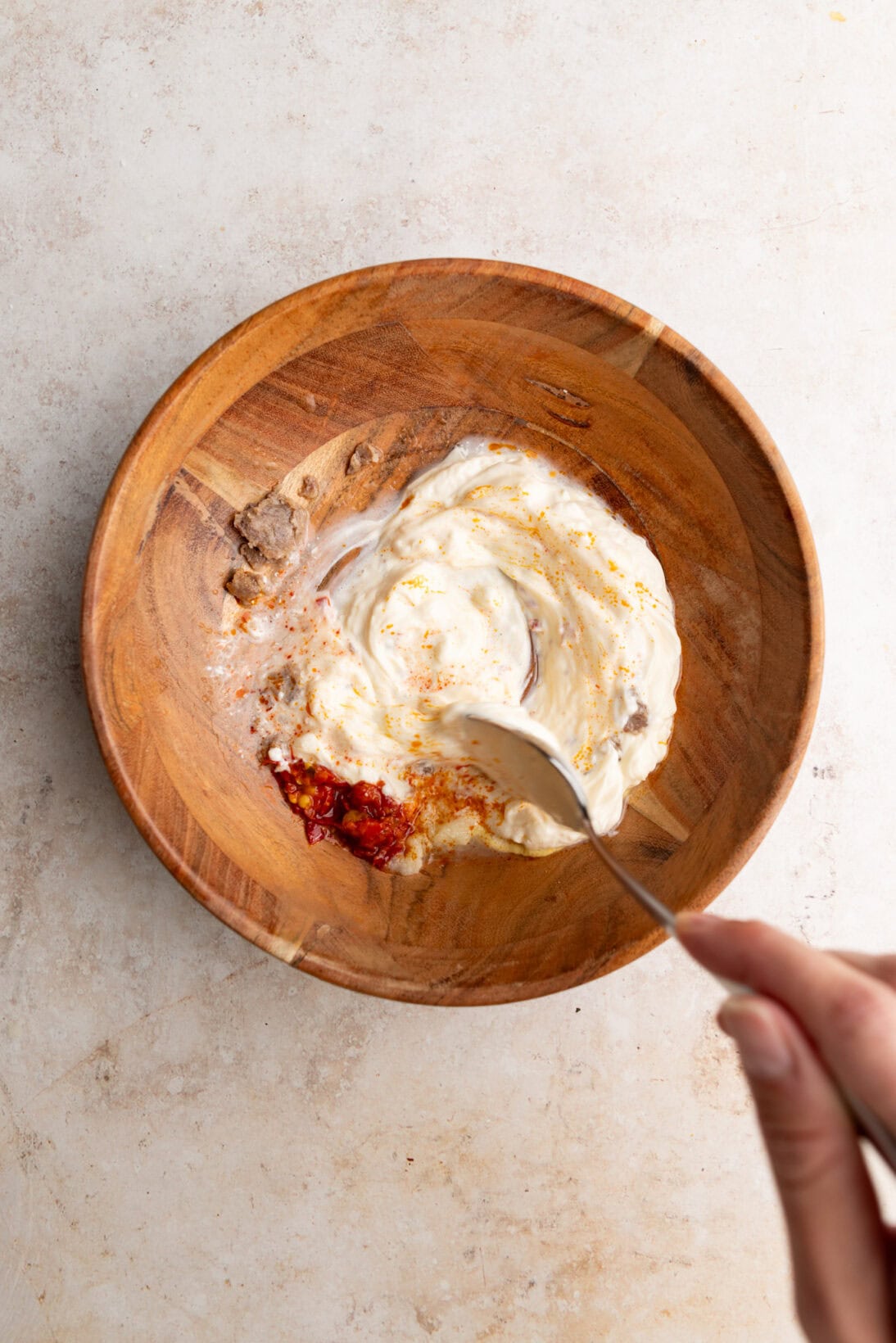 mixing the spicy dressing