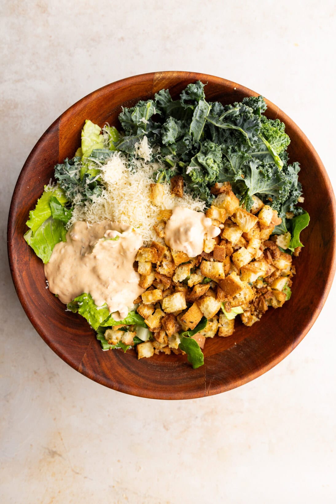 assembled spicy Caesar salad , not mixed in a. wooden bowl.