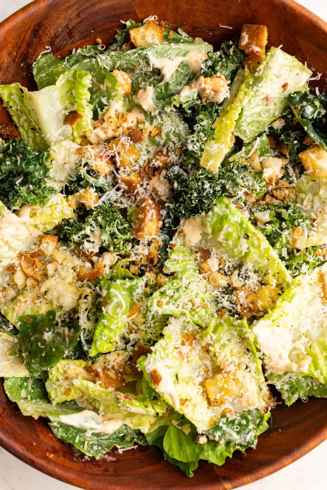 mixed and garnished spicy Caesar salad