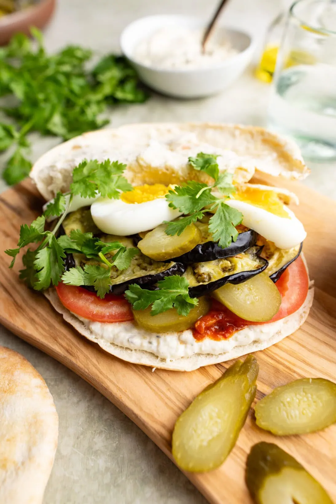 open sabich sandwich on a cutting board