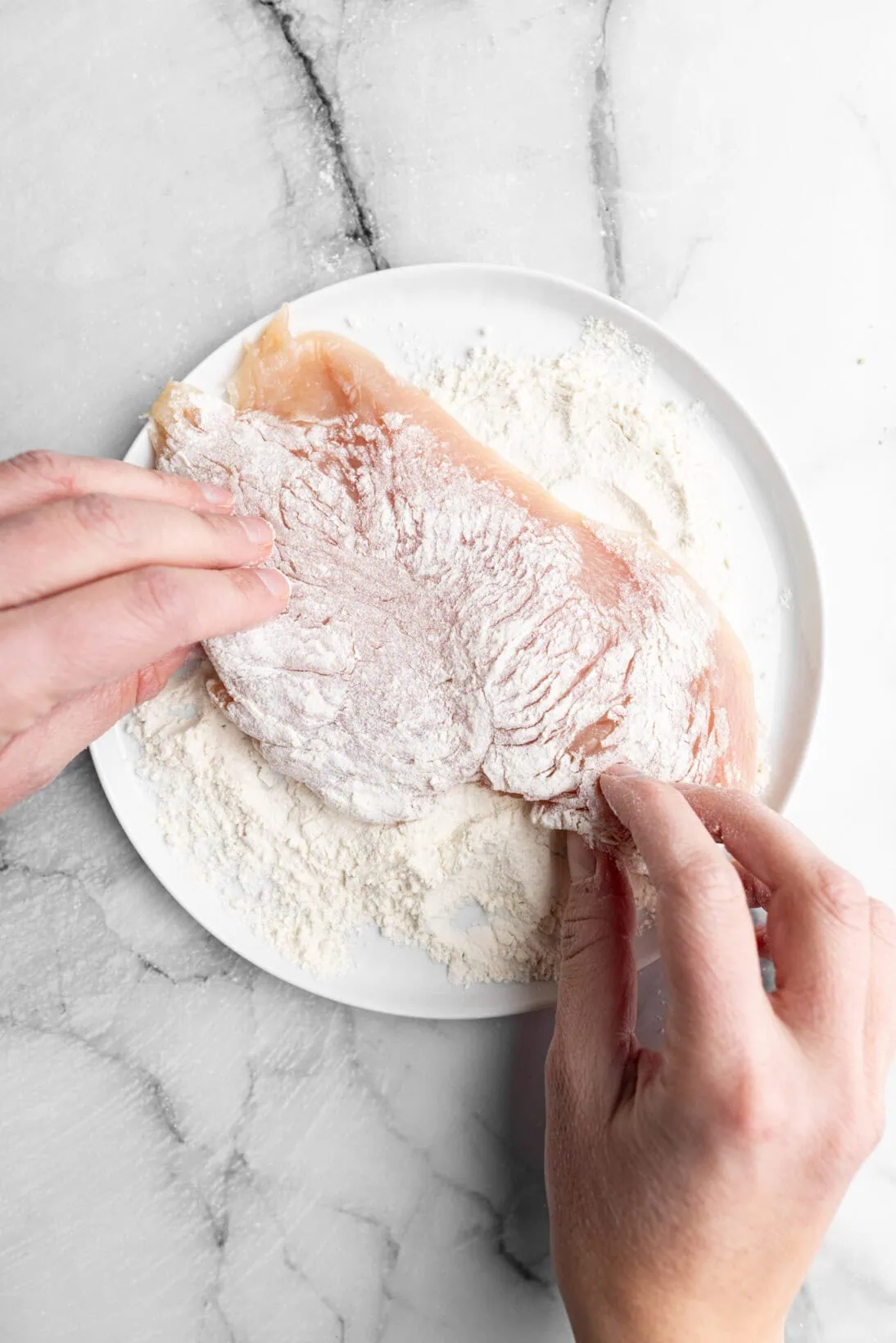 coating the chicken in flour