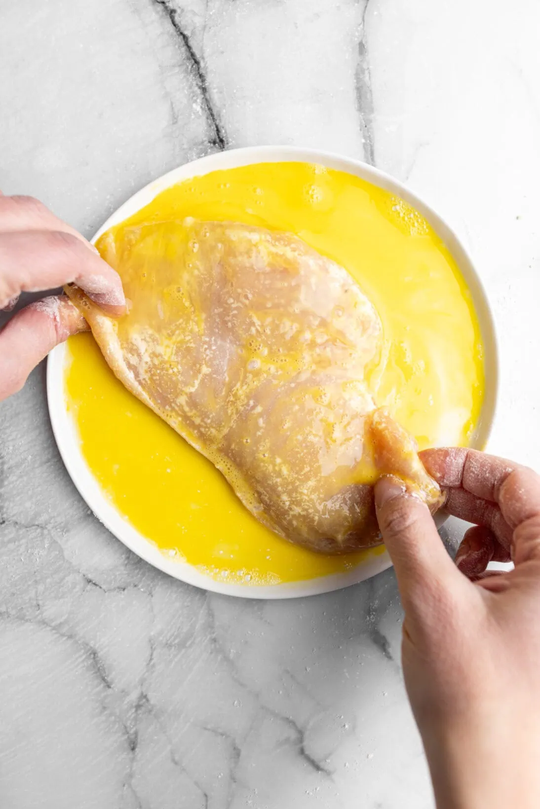 coating the chicken in egg