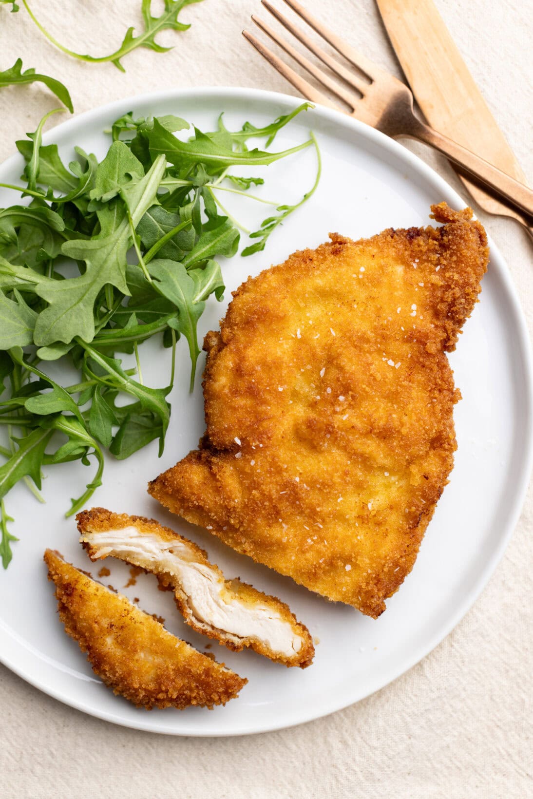 crispy breaded chicken cutlets served with a side of arugula. 