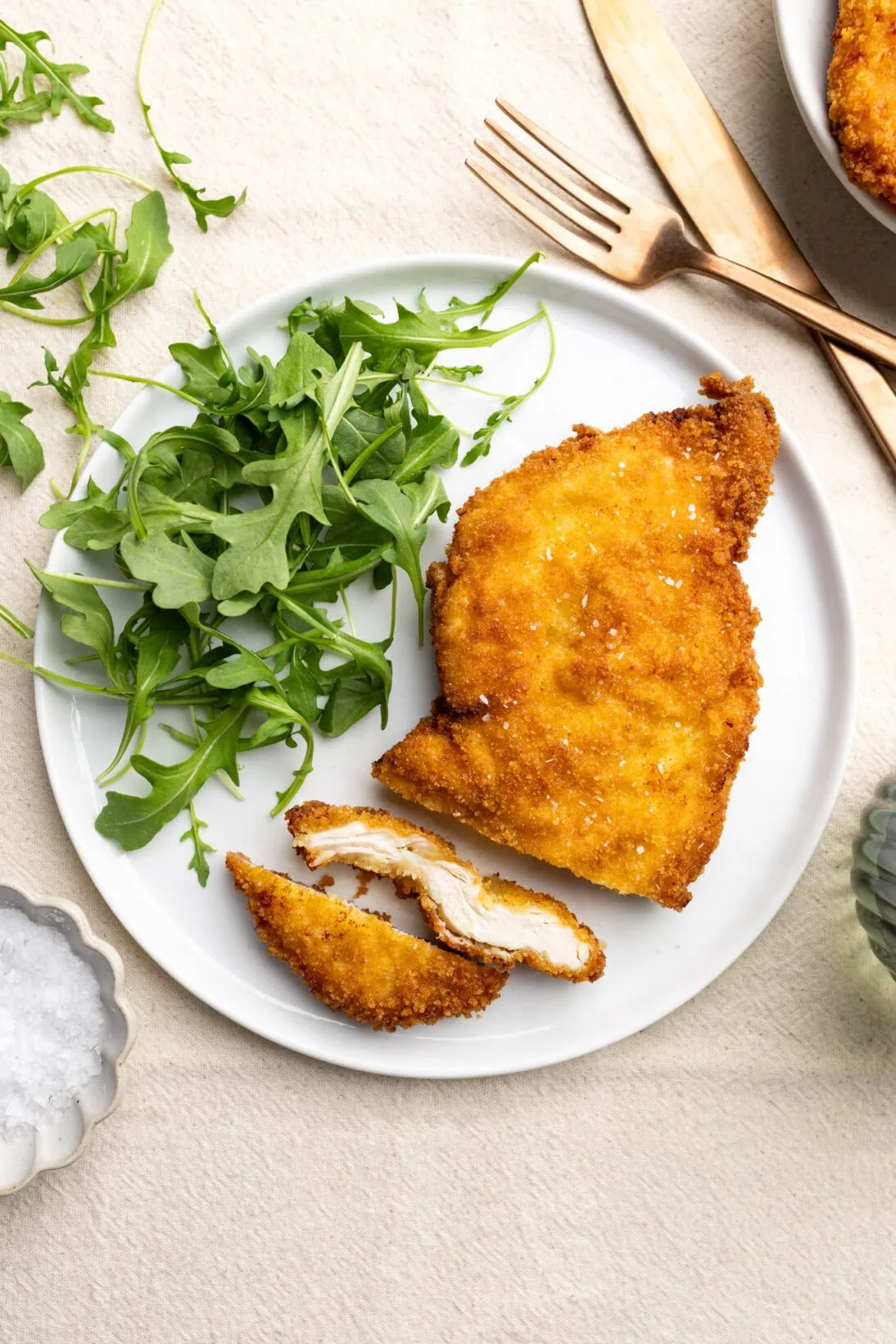 crispy breaded chicken cutlets served with a side of arugula. 