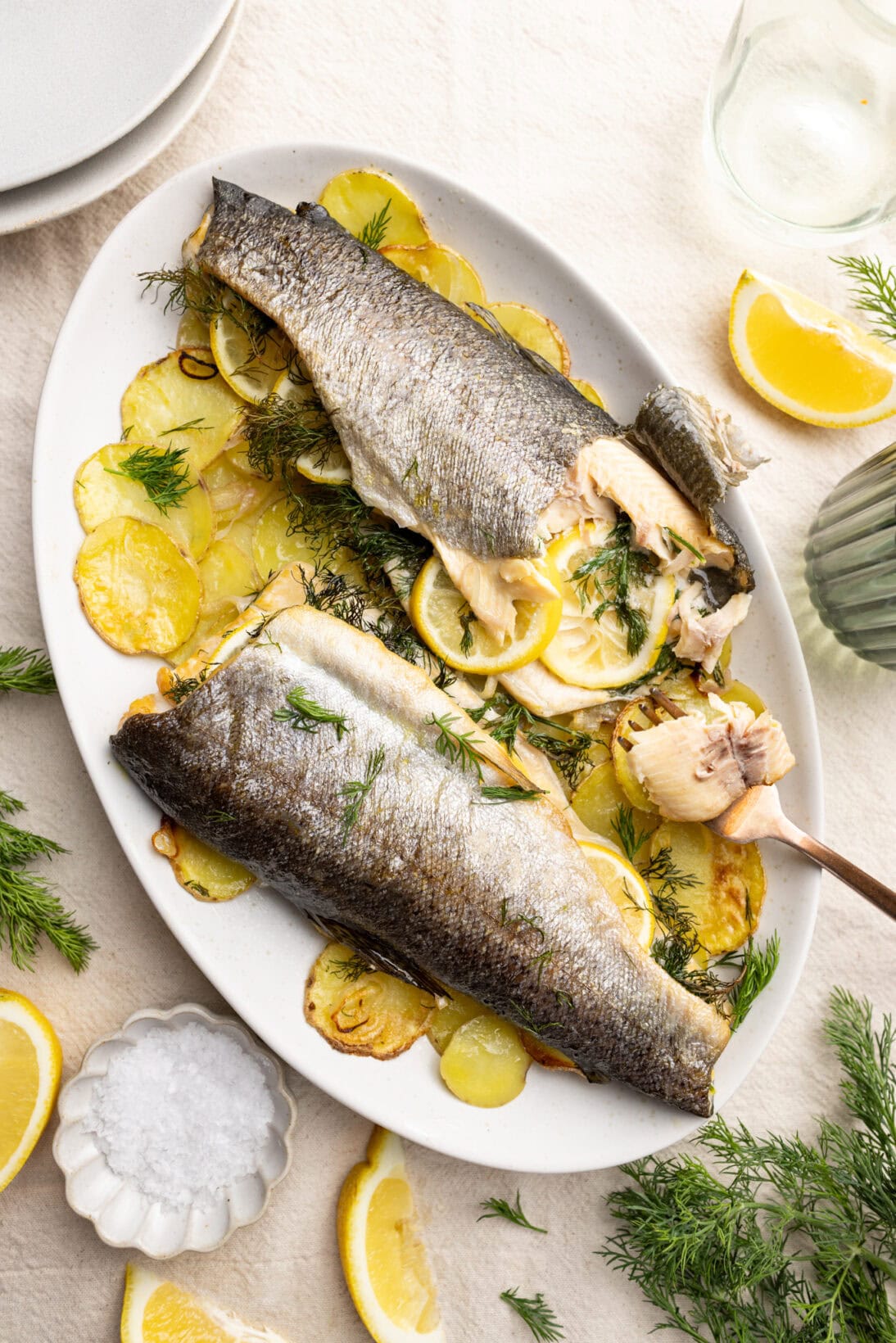 cooked and plated lemon roasted trout over scalloped potatoes