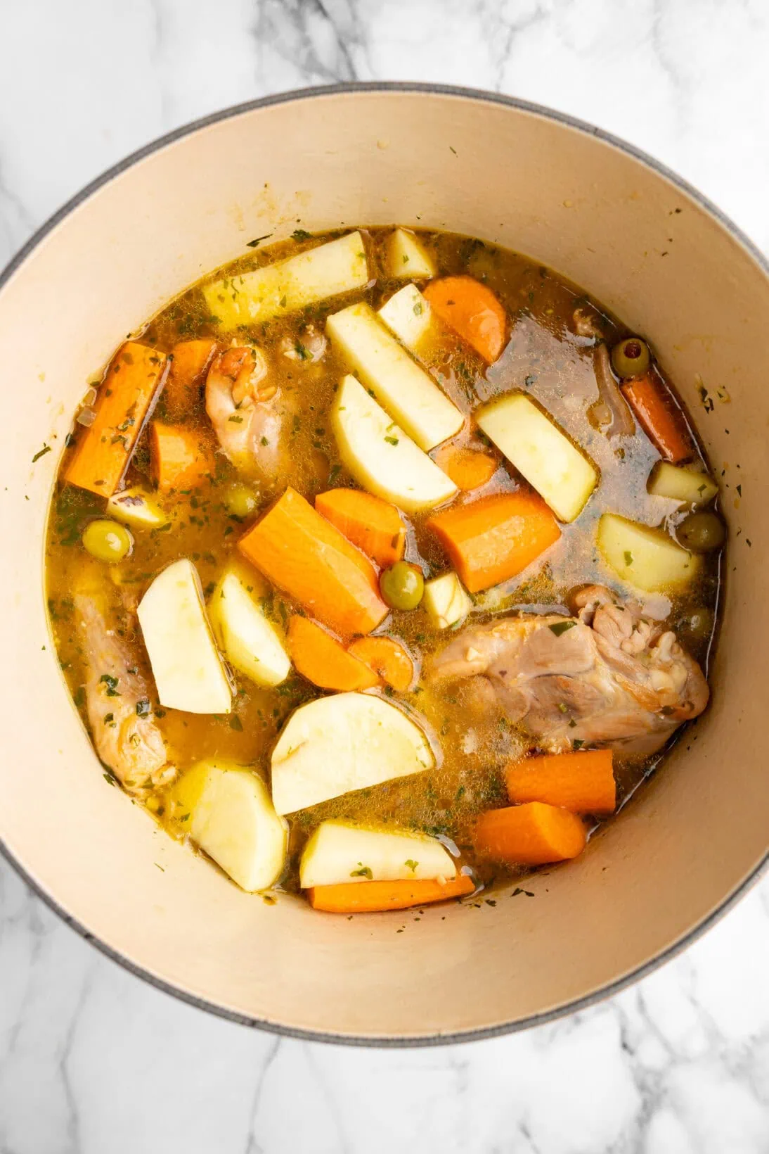 tossed the potatoes and carrots in the pot.