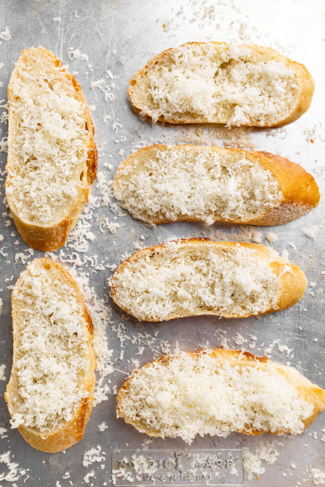 making the cheesy crostinis, sliced baguette with parm sprinkled on top