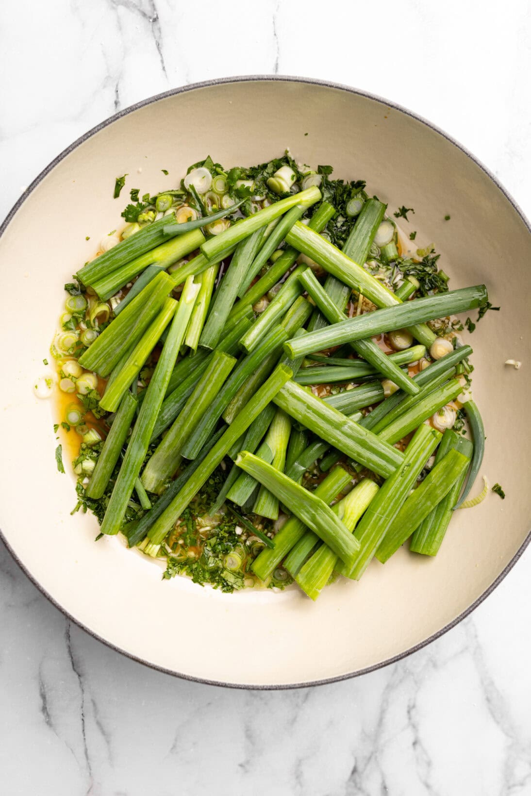 step by step: the sauce has simmered now adding in the green onions to steam the fish on top.