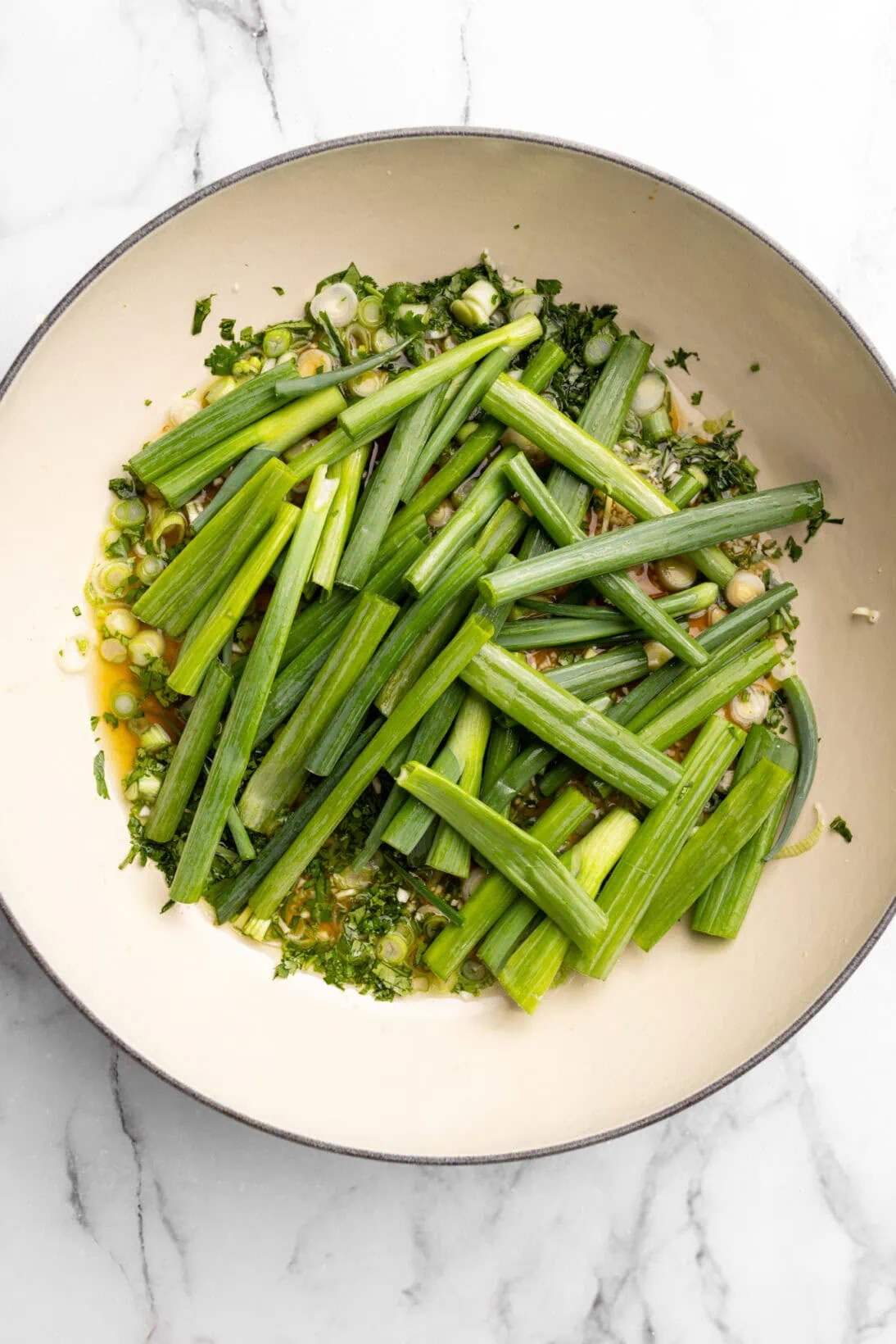 step by step: the sauce has simmered now adding in the green onions to steam the fish on top.