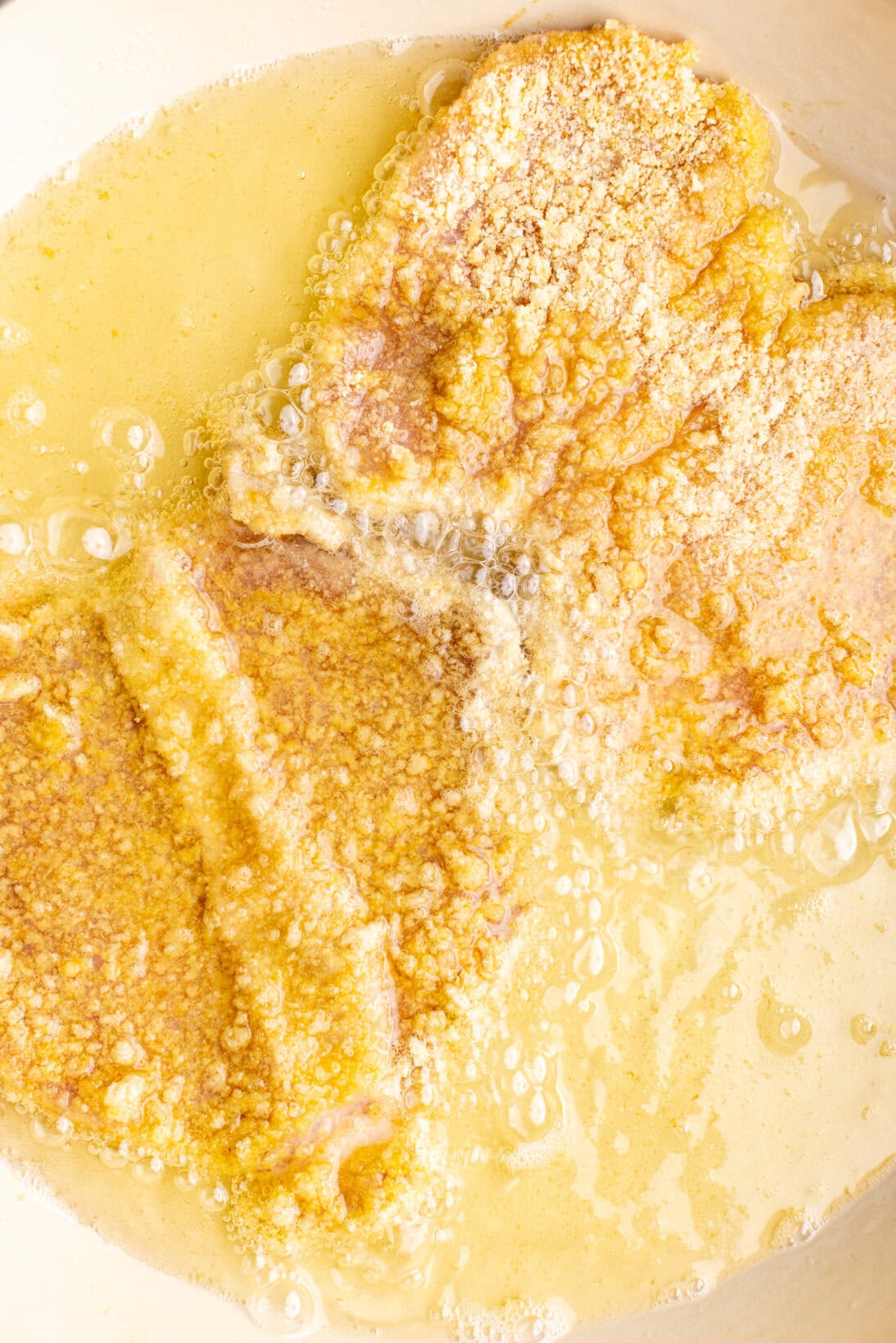 frying the pork schnitzel