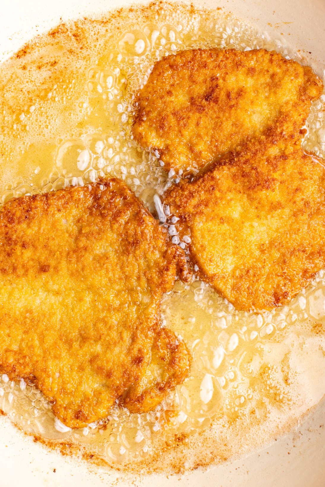 frying the pork schnitzel