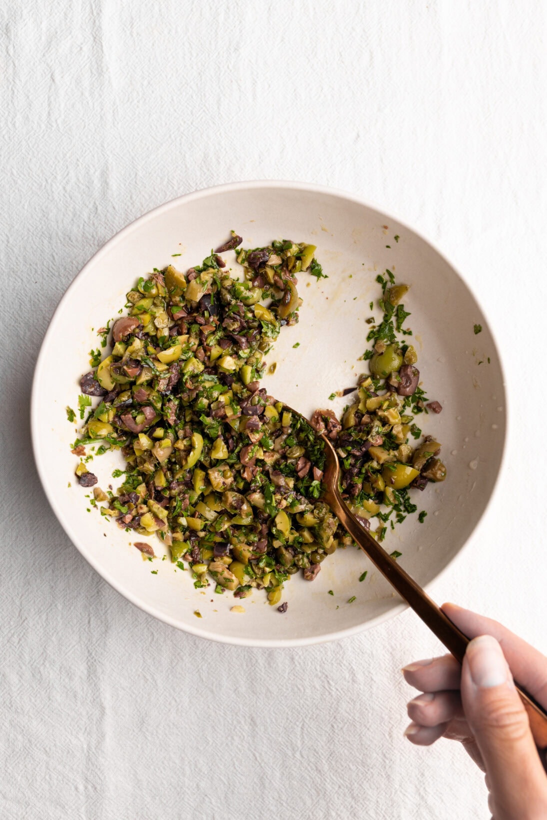 mixing the the olive tapenade