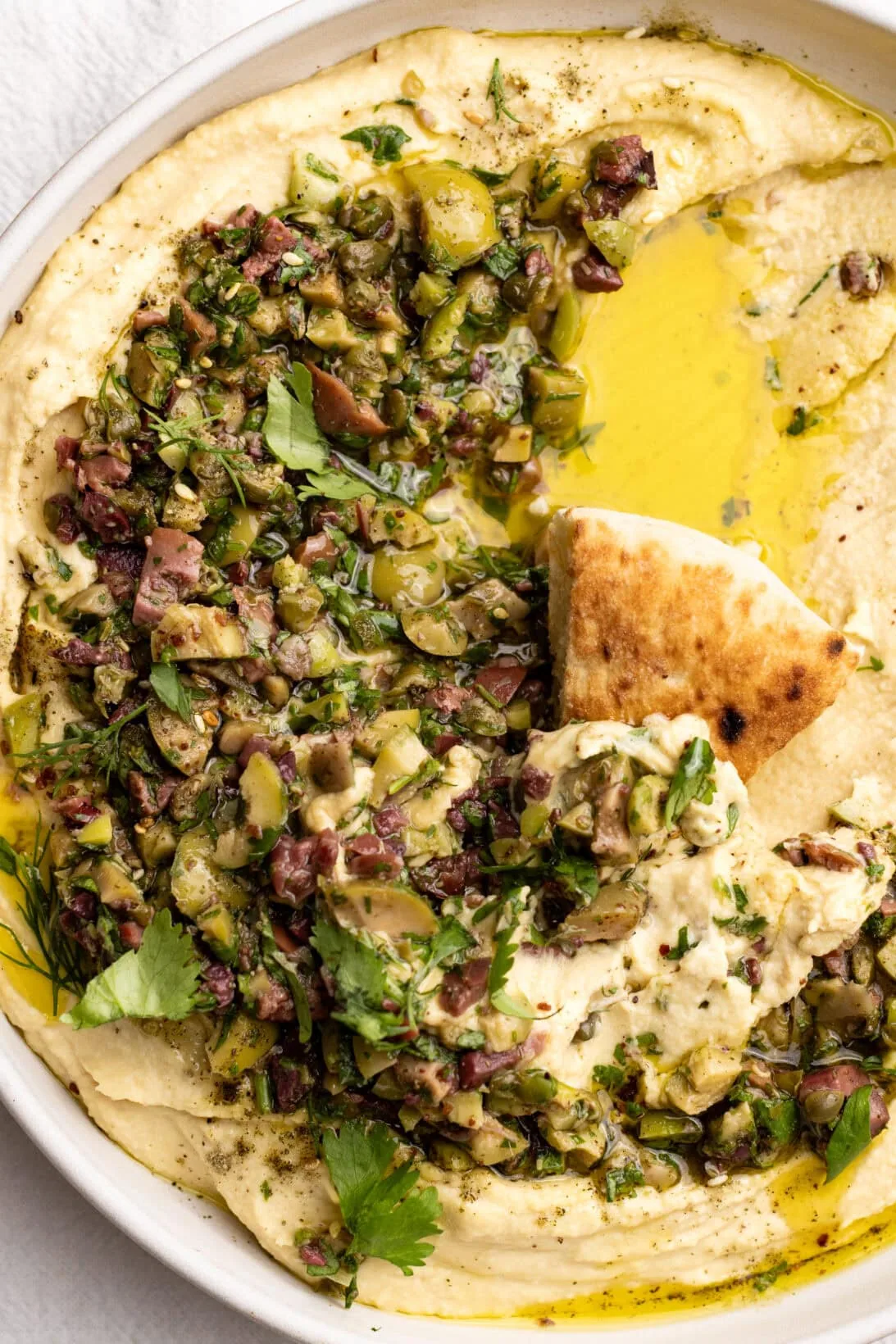 a bowl of olive tapenade hummus 