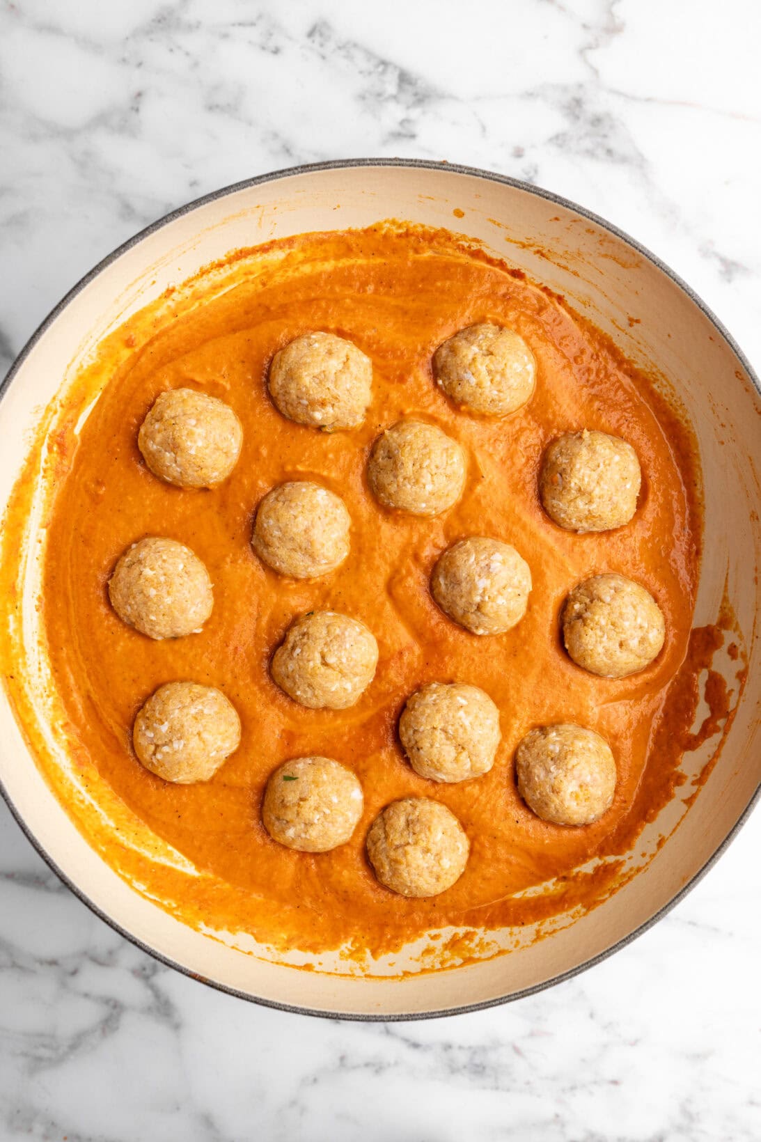 step by step: adding the raw chicken meatballs to simmer in the sauce.