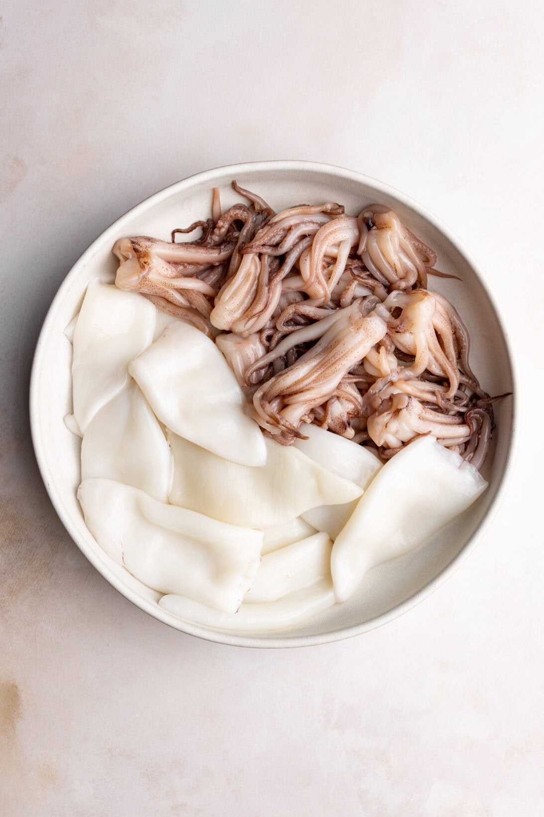 raw squid, cleaned tubes and tentacles.