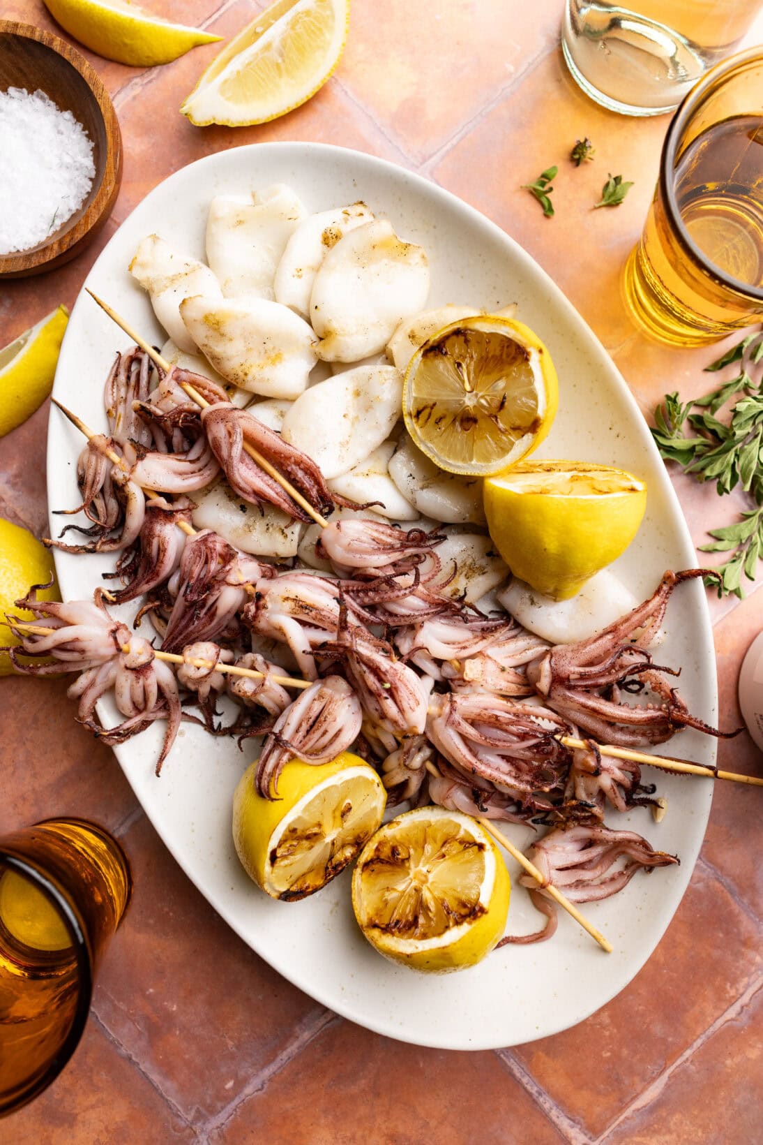 a plate of grilled squid (tubes and tentacles), and grilled lemon.