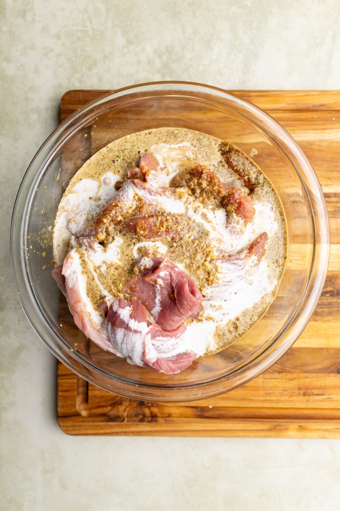 step by step: pouring the marinade over the prepped pork