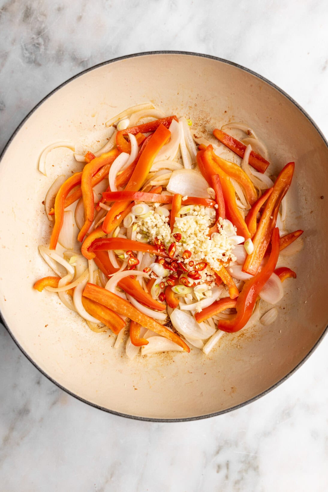 Step by step: cooking the onions, red bell pepper, scallion whites, garlic, and chilis.