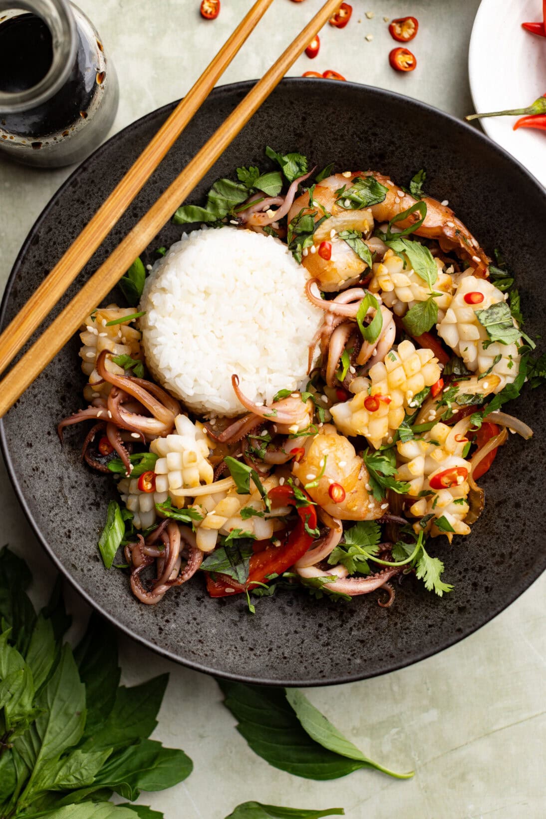 a bowl of Thai spicy squid stir fry served with sushi rice.