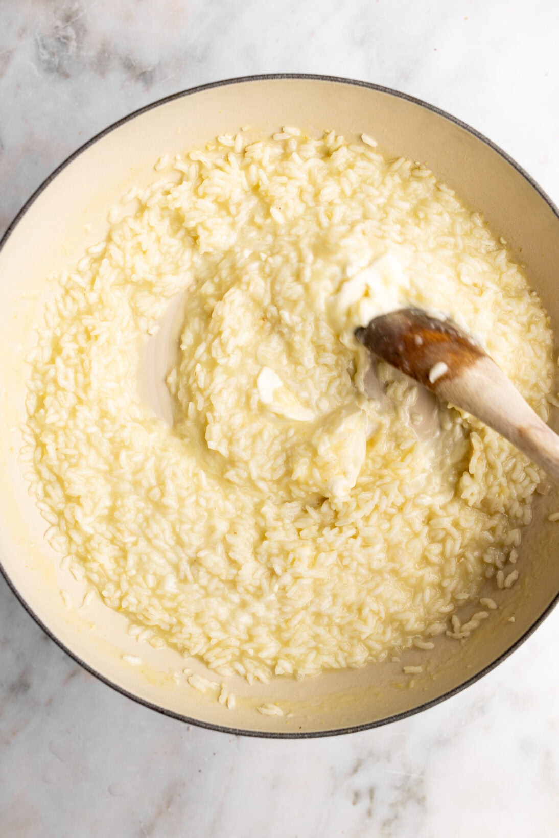 Step by step: folding in the mascarpone cheese into the roasted garlic risotto.