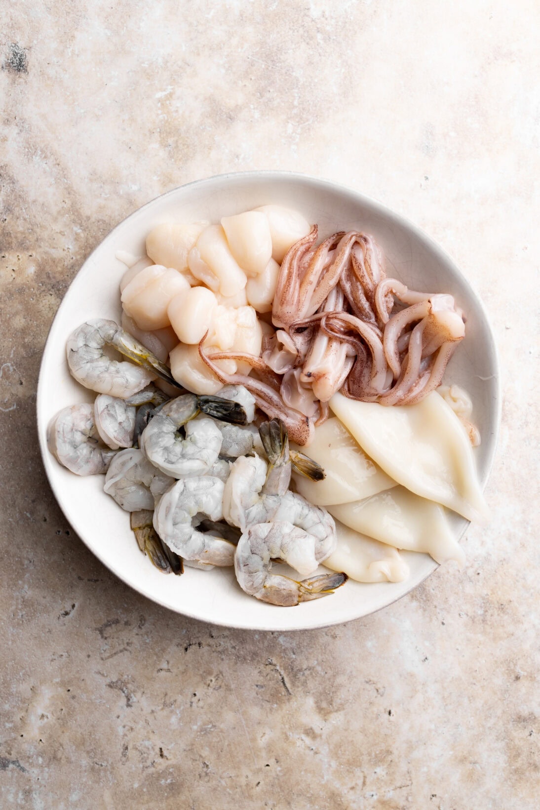 bowl of seafood: shrimp, scallops, and squid tubes and tentacles. 