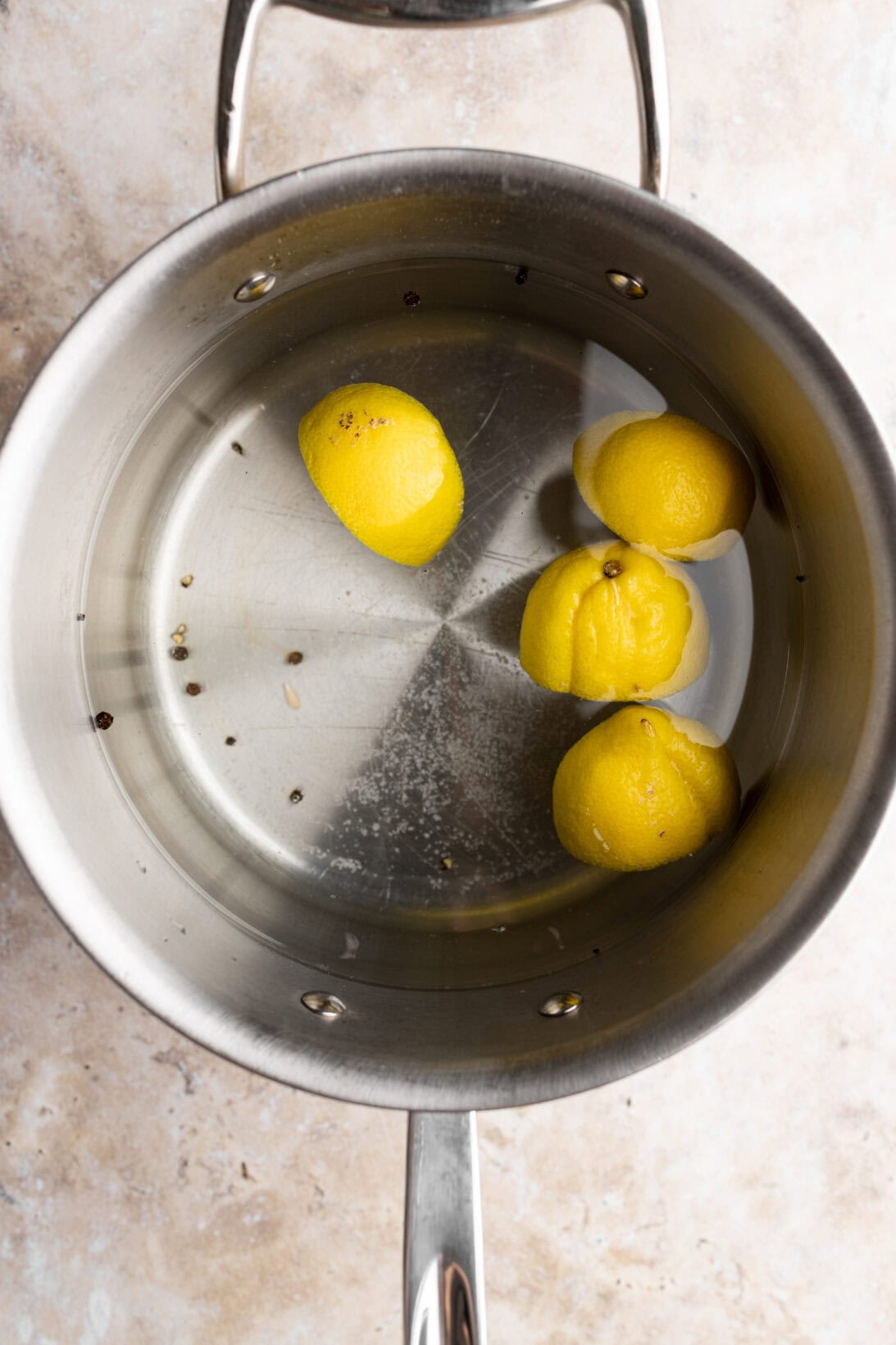step by step: pot of salted water with lemons to cook the seafood.