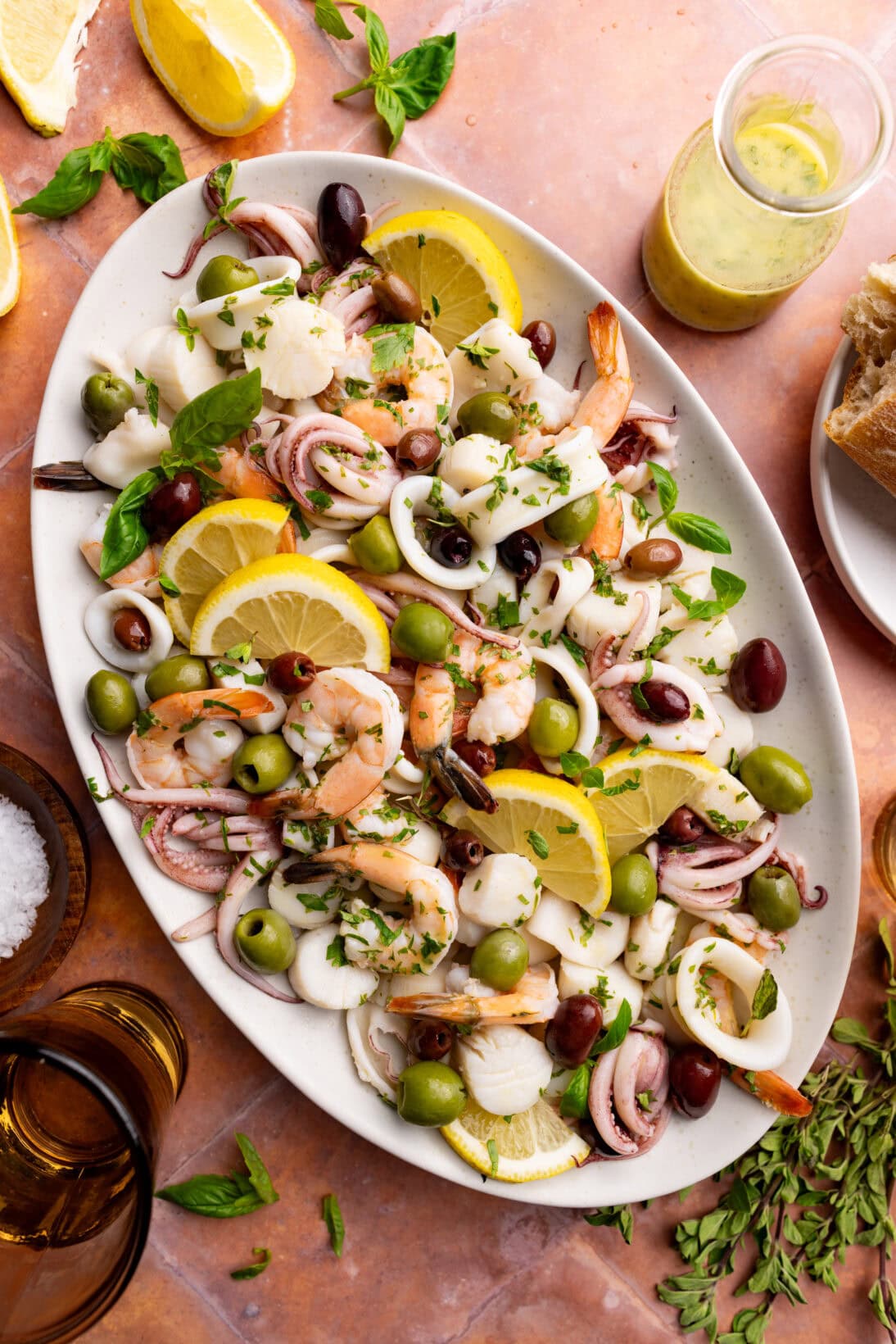 a serving plate of insalata di mare. served with slices of lemon.
