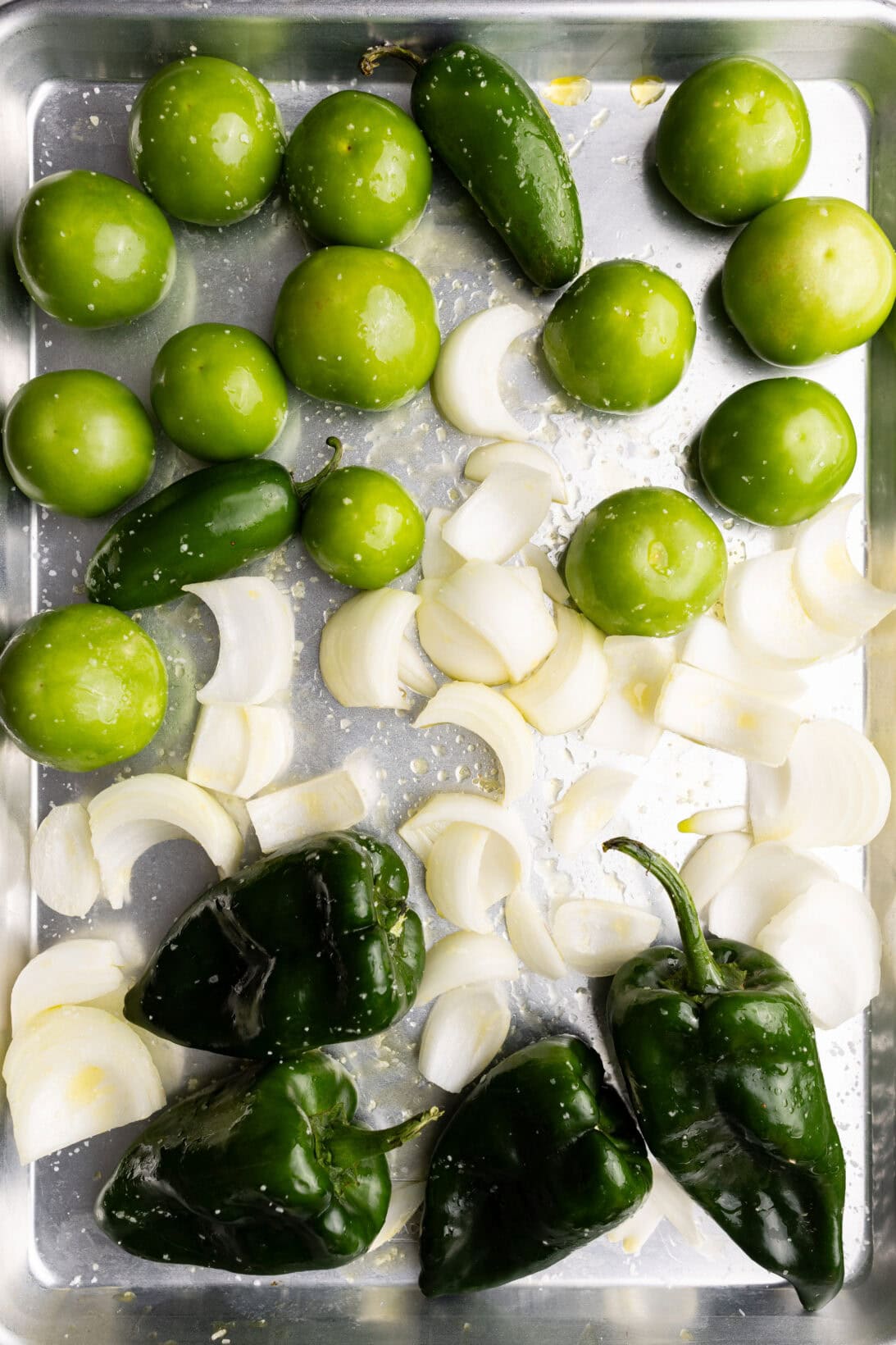 roasting the poblano peppers, onions, tomatillos, and jalapeños