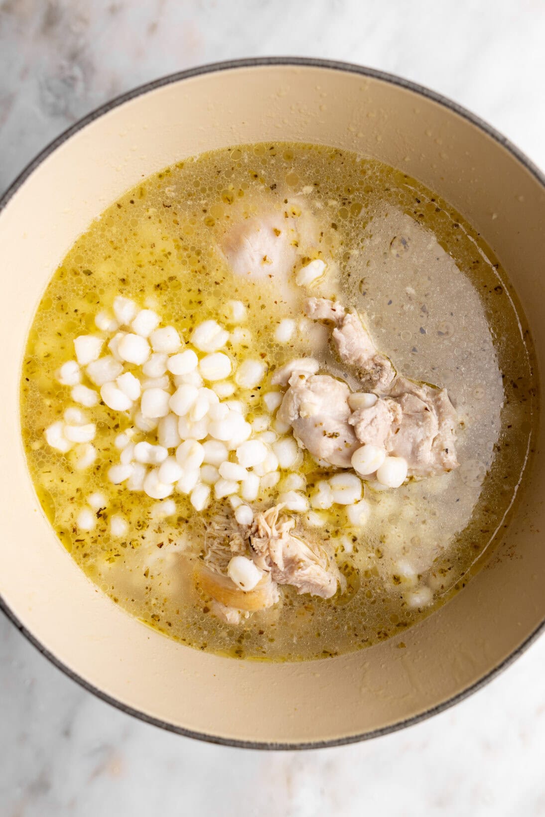 step by step: adding the hominy and broth.