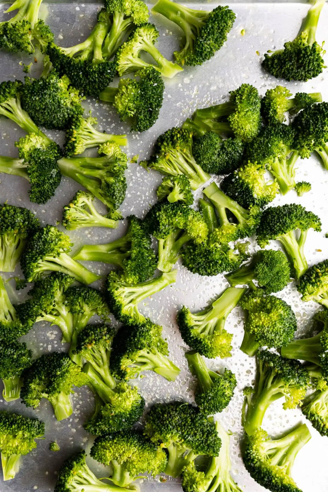 raw broccoli prepped to be roasted