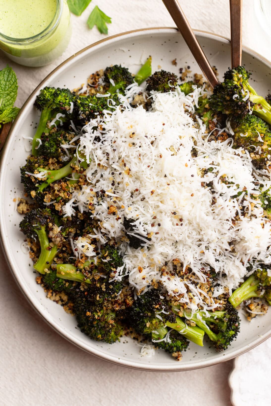 roasted broccoli salad topped with crispy quinoa and 
